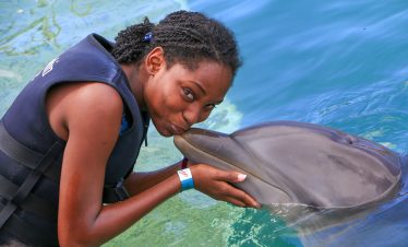 Girl kissing Dolphin