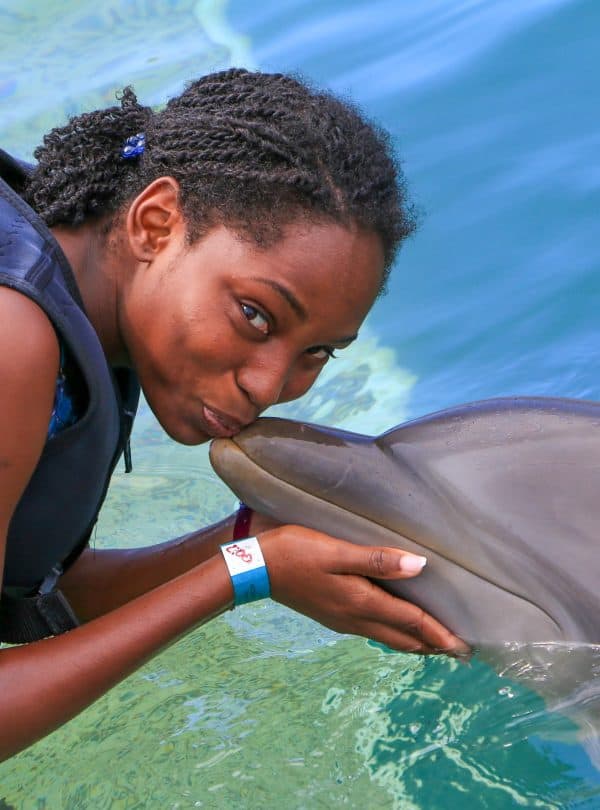 Girl kissing Dolphin